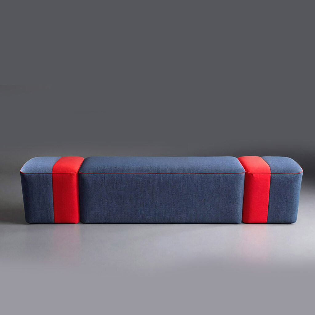 Monaco Longboard Bench by Cadenza Visioni, designed by Annette Wernick. A modern upholstered bench featuring navy blue and vibrant red color blocking with a sleek, elongated silhouette.